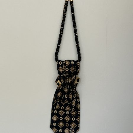 Handmade black silk necktie with a gold and white geometric pattern and decorative gold accents necktie.