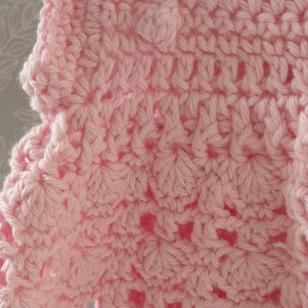 View of the textured waist between the top and skirt part of the dress