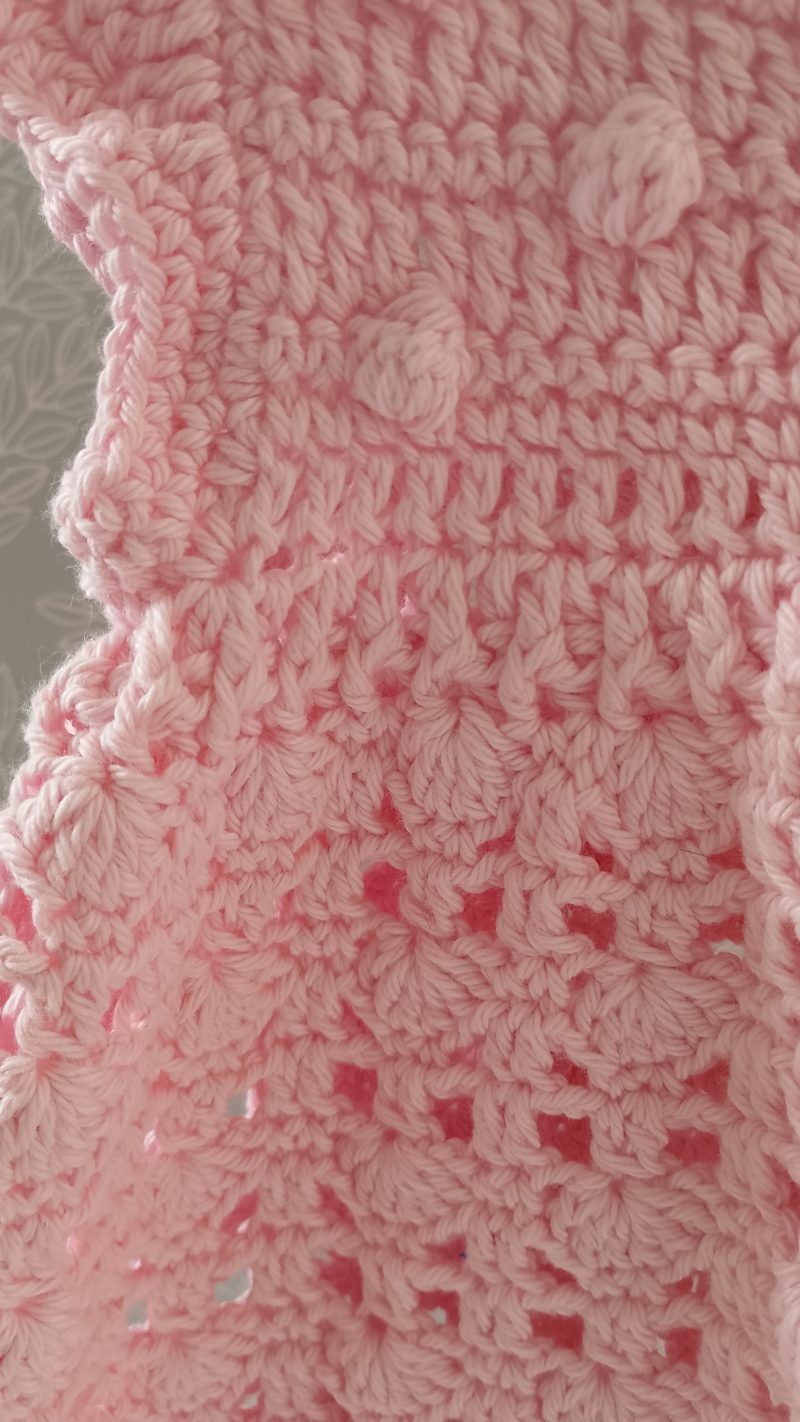 View of the textured waist between the top and skirt part of the dress