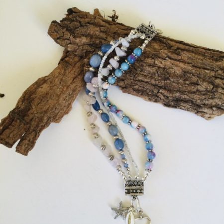 Multistrand bracelet featuring semiprecious stones in shades of blue, pink and silvery