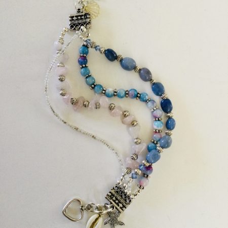 Multistrand bracelet featuring semiprecious stones in shades of blue, pink and silvery
