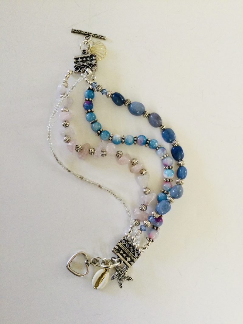 Multistrand bracelet featuring semiprecious stones in shades of blue, pink and silvery