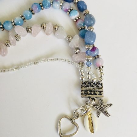 Multistrand bracelet featuring semiprecious stones in shades of blue, pink and silvery