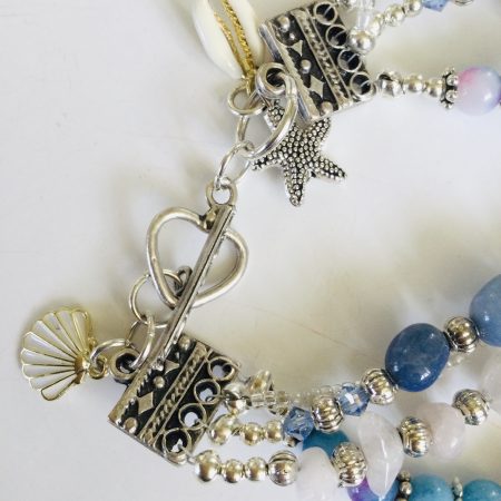Multistrand bracelet featuring semiprecious stones in shades of blue, pink and silvery