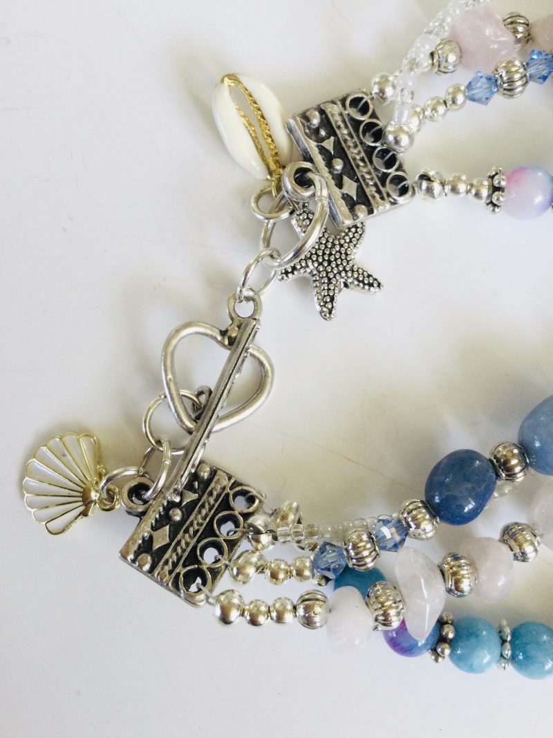 Multistrand bracelet featuring semiprecious stones in shades of blue, pink and silvery