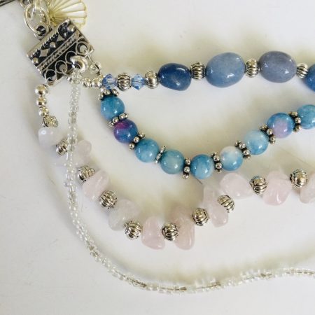 Multistrand bracelet featuring semiprecious stones in shades of blue, pink and silvery