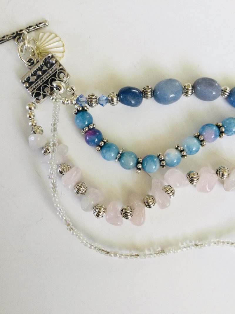 Multistrand bracelet featuring semiprecious stones in shades of blue, pink and silvery