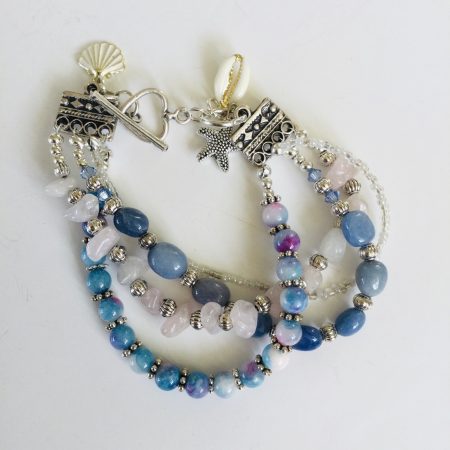 Multistrand bracelet featuring semiprecious stones in shades of blue, pink and silvery