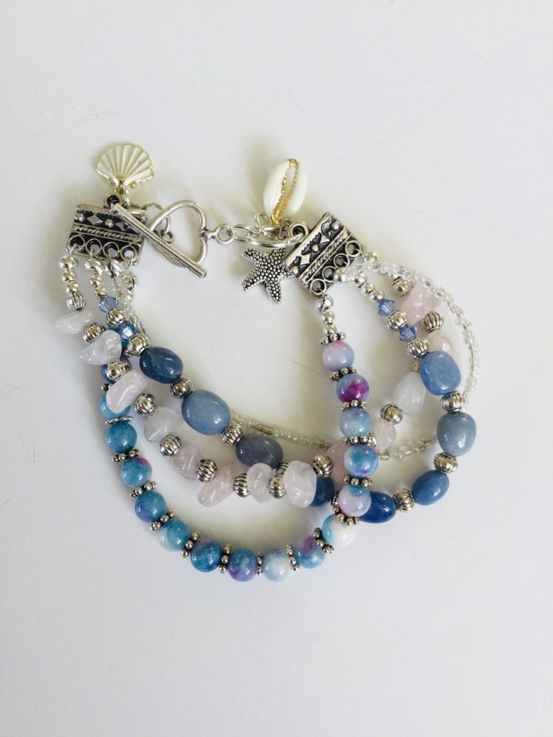 Multistrand bracelet featuring semiprecious stones in shades of blue, pink and silvery