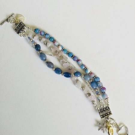 Multistrand bracelet featuring semiprecious stones in shades of blue, pink and silvery