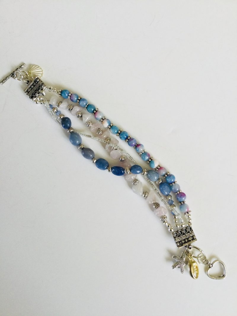 Multistrand bracelet featuring semiprecious stones in shades of blue, pink and silvery