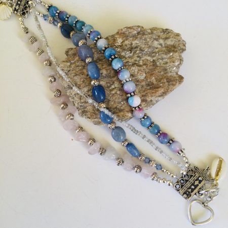Multistrand bracelet featuring semiprecious stones in shades of blue, pink and silvery