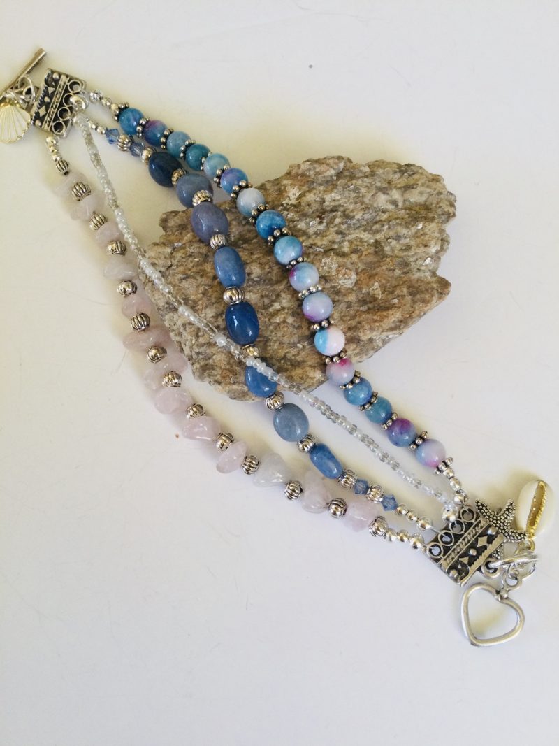 Multistrand bracelet featuring semiprecious stones in shades of blue, pink and silvery