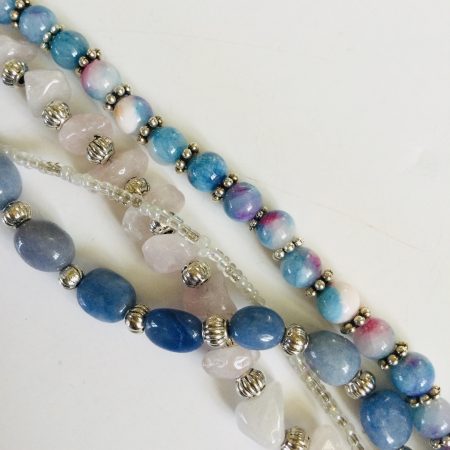Multistrand bracelet featuring semiprecious stones in shades of blue, pink and silvery