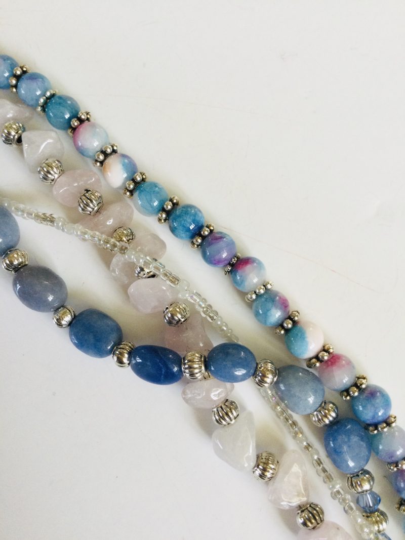 Multistrand bracelet featuring semiprecious stones in shades of blue, pink and silvery