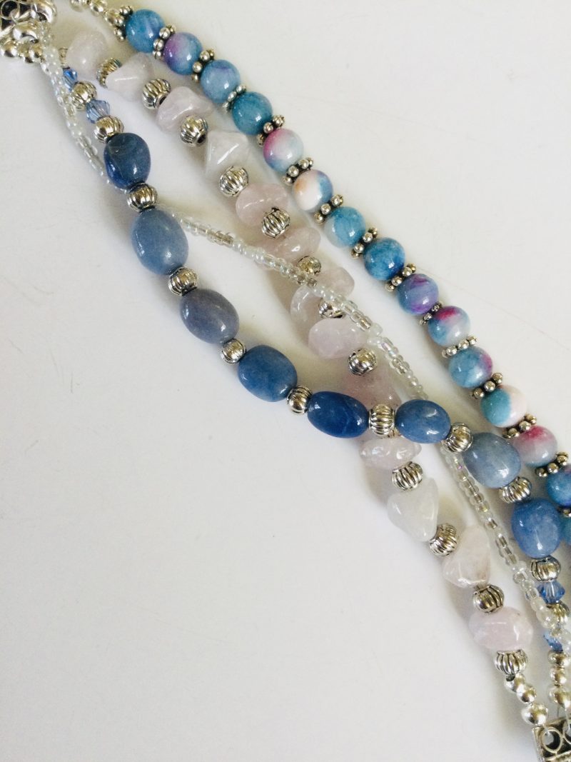 Multistrand bracelet featuring semiprecious stones in shades of blue, pink and silvery