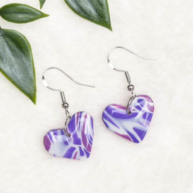 Small, heart shaped polymer clay earrings in various colours.