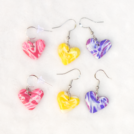 Small, heart shaped polymer clay earrings in various colours.