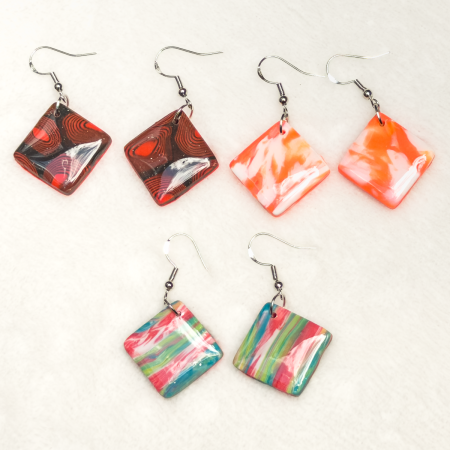 Small, square shaped polymer clay earrings in various colours.