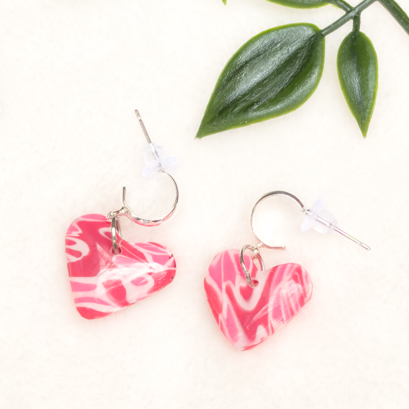 Small, heart shaped polymer clay earrings in various colours.