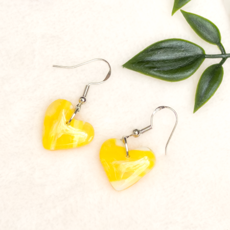 Small, heart shaped polymer clay earrings in various colours.