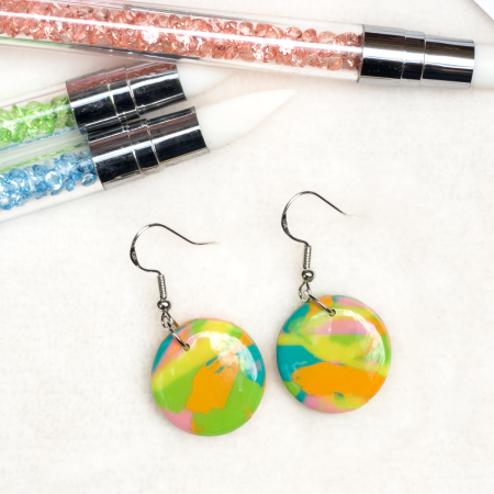 Small, circle polymer clay earrings in various colours.
