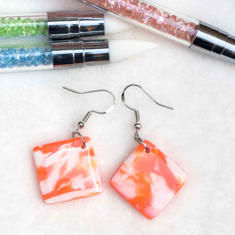 Small, square shaped polymer clay earrings in various colours.