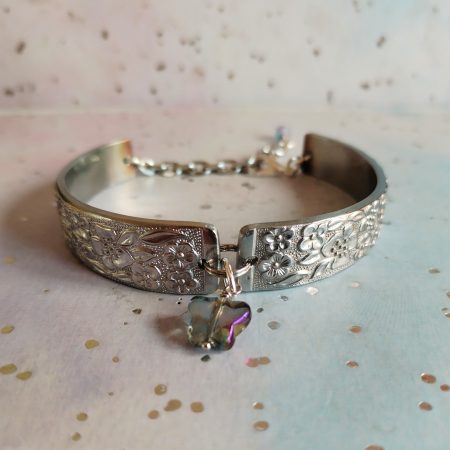 Handmade stainless steel spoon handle bracelet with glass butterfly charm.