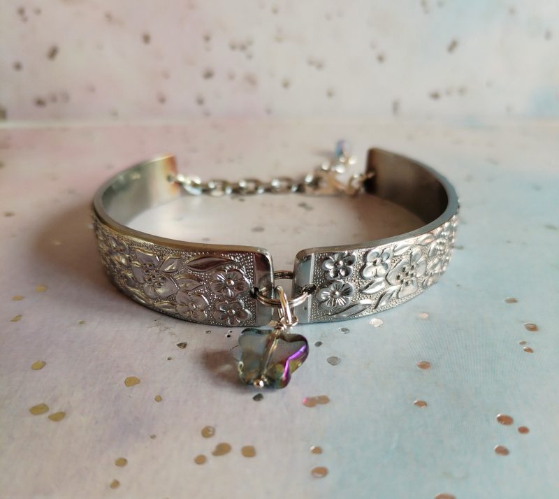 Handmade stainless steel spoon handle bracelet with glass butterfly charm.