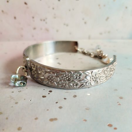 Handmade stainless steel spoon handle bracelet with glass butterfly charm.