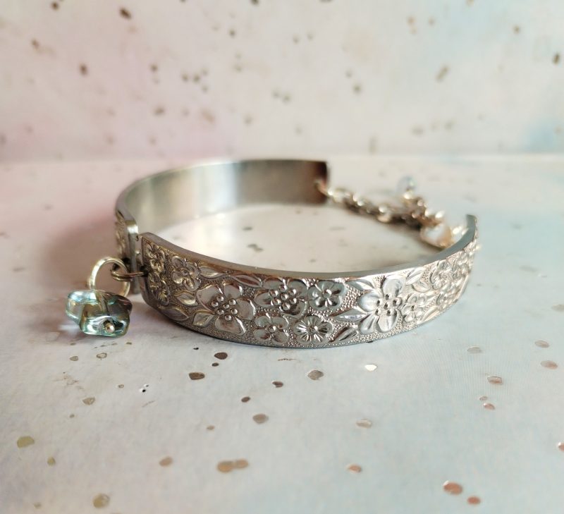 Handmade stainless steel spoon handle bracelet with glass butterfly charm.