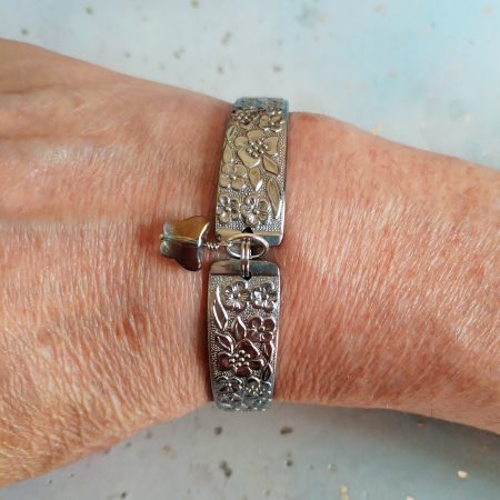 Handmade stainless steel spoon handle bracelet with glass butterfly charm.