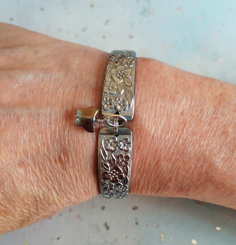 Handmade stainless steel spoon handle bracelet with glass butterfly charm.