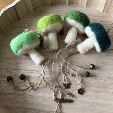 Hand felted forest inspired mushroom hanger.