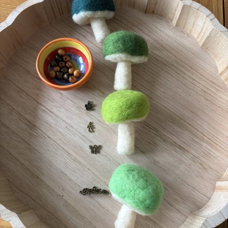 Hand felted forest inspired mushroom hanger.