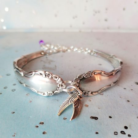 Flirtation silver plated spoon handle bracelet with Angel wing charms.