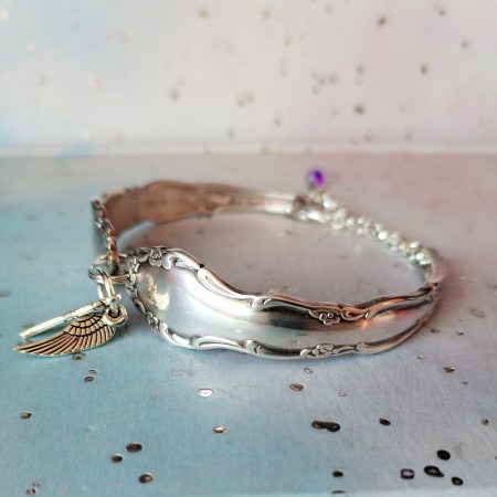 Flirtation silver plated spoon handle bracelet with Angel wing charms.