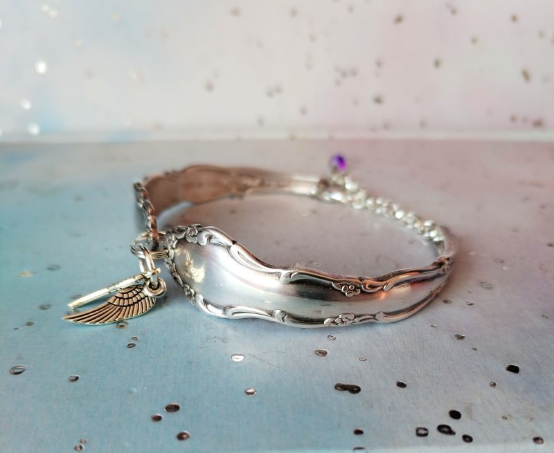 Flirtation silver plated spoon handle bracelet with Angel wing charms.
