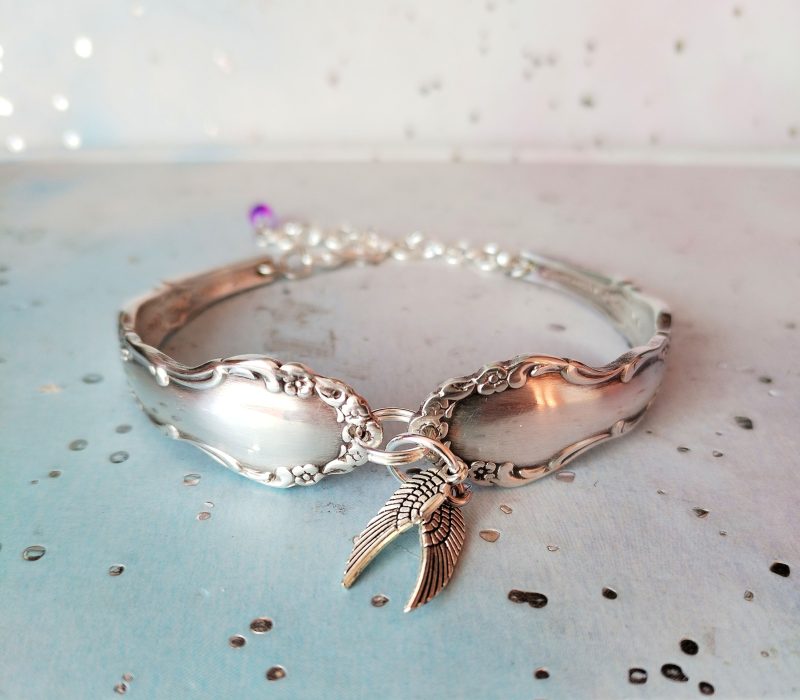 Flirtation silver plated spoon handle bracelet with Angel wing charms.