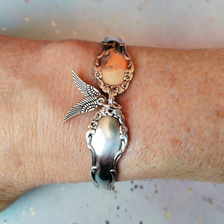 Flirtation silver plated spoon handle bracelet with Angel wing charms.