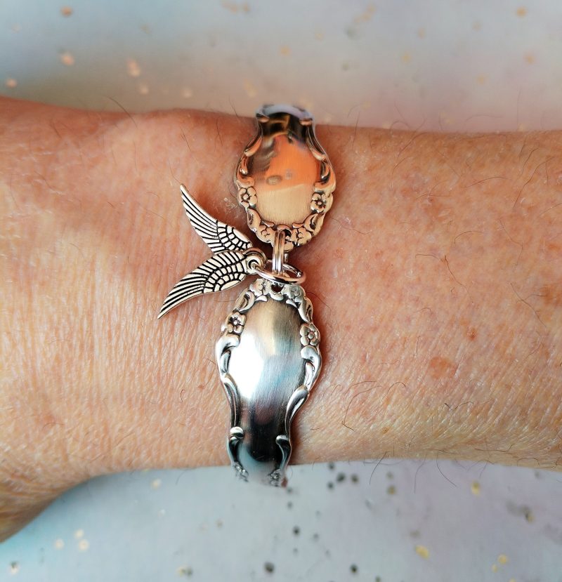 Flirtation silver plated spoon handle bracelet with Angel wing charms.