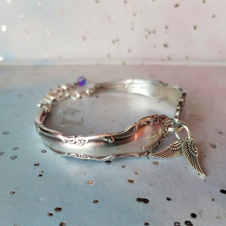Flirtation silver plated spoon handle bracelet with Angel wing charms.
