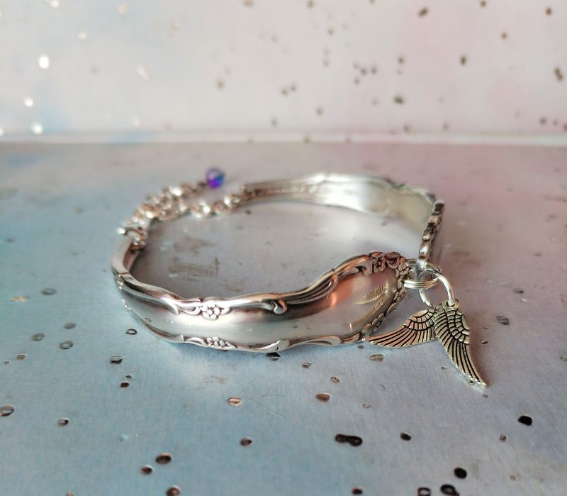 Flirtation silver plated spoon handle bracelet with Angel wing charms.