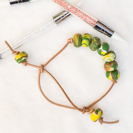 Beaded clay bracelet in various colours.
