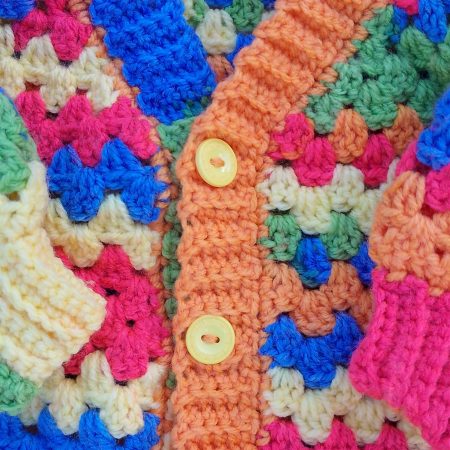 Yellow Button Closure of Crochet Cardigan