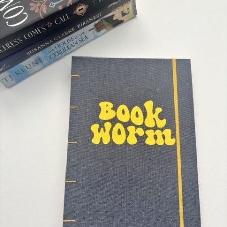 A5 Coptic stitch sketchbook | 48 pages | Blue book cloth cover | Yellow Bookworm | Elastic closure | Hand stitched