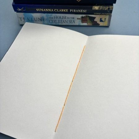 A5 Coptic stitch sketchbook | 48 pages | Blue book cloth cover | Yellow Bookworm | Elastic closure | Hand stitched