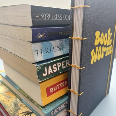 A5 Coptic stitch sketchbook | 48 pages | Blue book cloth cover | Yellow Bookworm | Elastic closure | Hand stitched