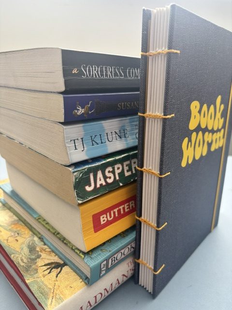 A5 Coptic stitch sketchbook | 48 pages | Blue book cloth cover | Yellow Bookworm | Elastic closure | Hand stitched