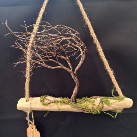 Windswept wire tree on natural driftwood